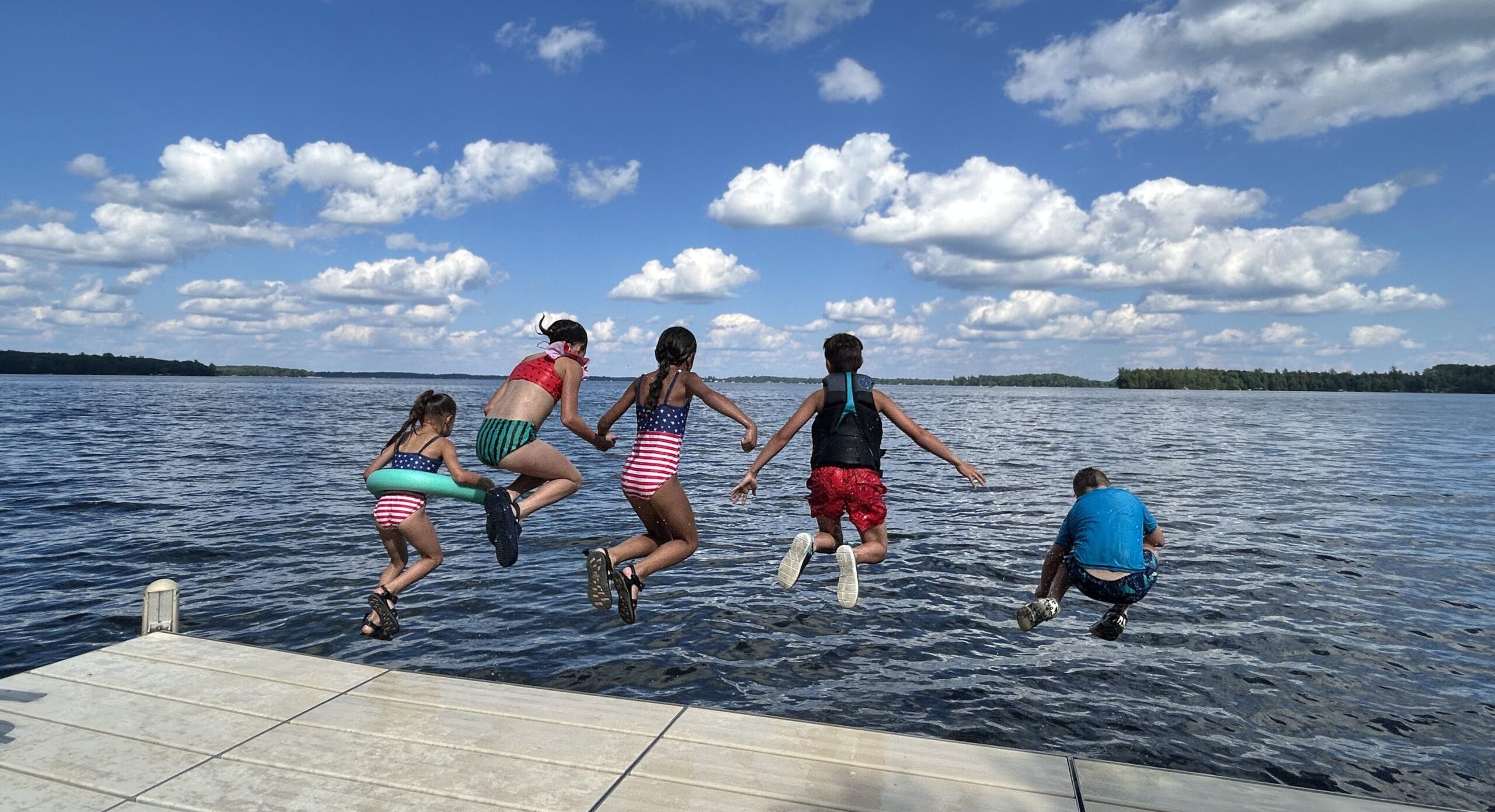 Kids jumping in lake