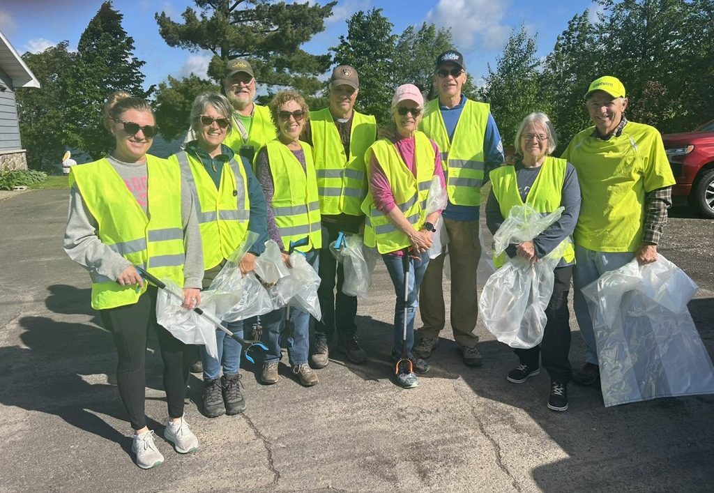Adopt-a-Highway volunteers in safety vests with trash bags
