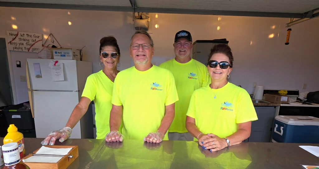 Four volunteers in association shirts