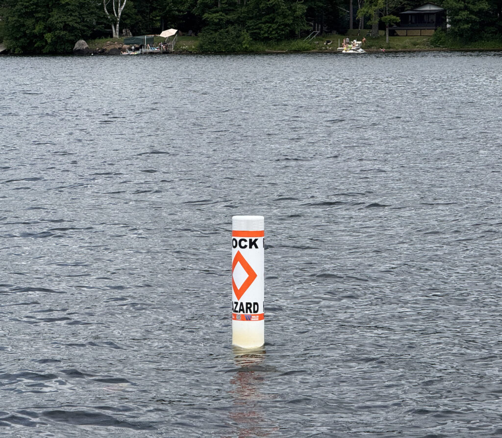 White hazard buoy with an orange diamond marking
