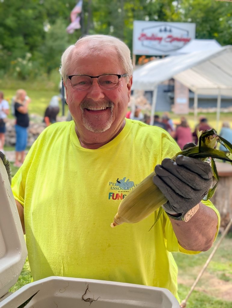 Volunteer handing out corn