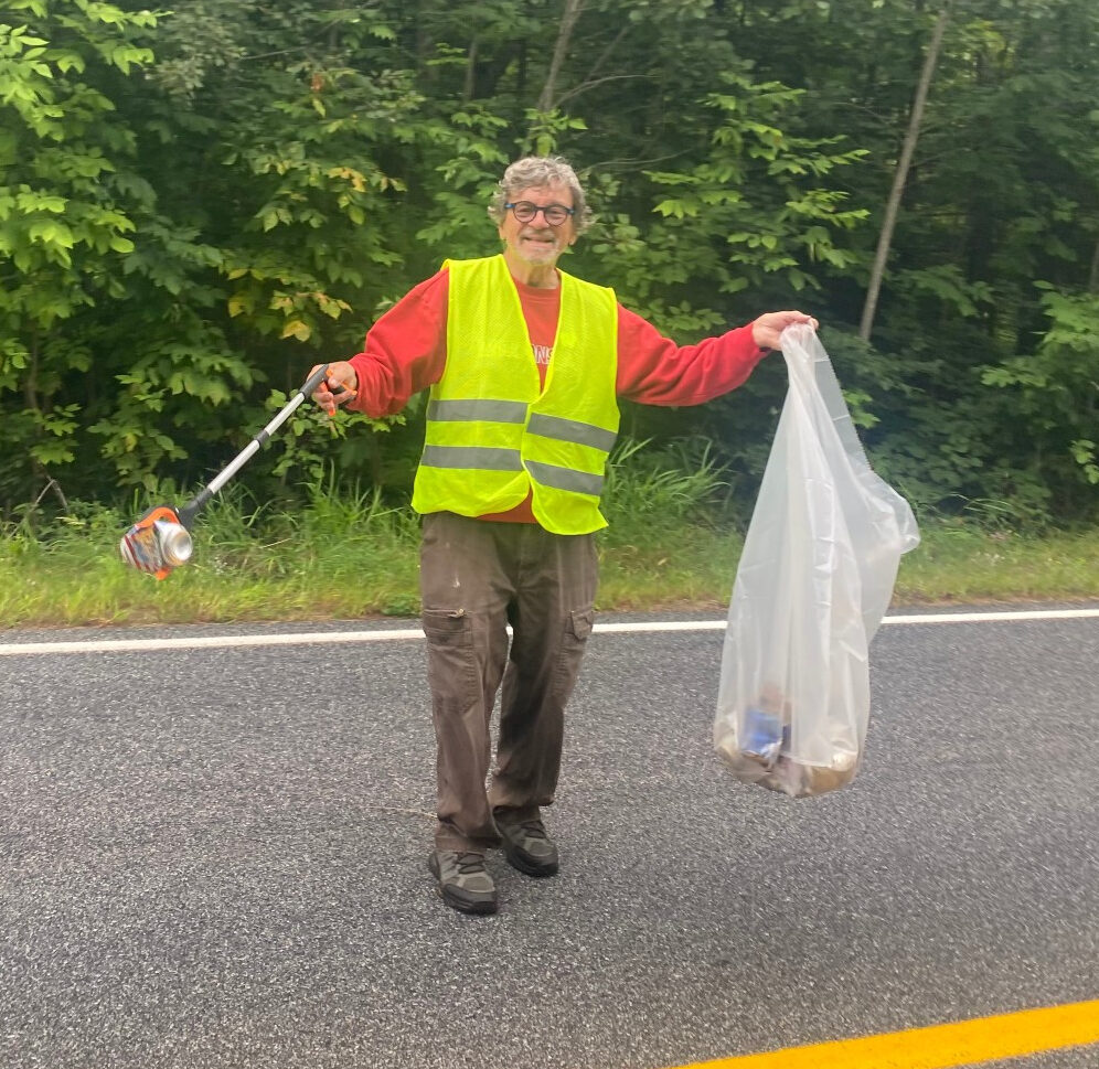Adopt a Highway volunteer collecting trash along the section of the highway Pelican Lake Association keeps clean.